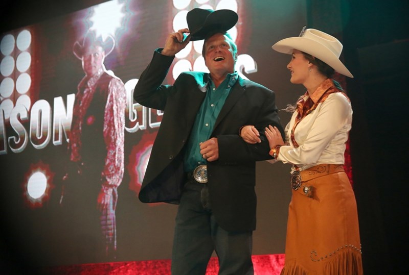 Jason Glass tips his hat to the audience at the 2016 Calgary Stampede Rangeland Derby tarp auction on March 17 in Calgary.