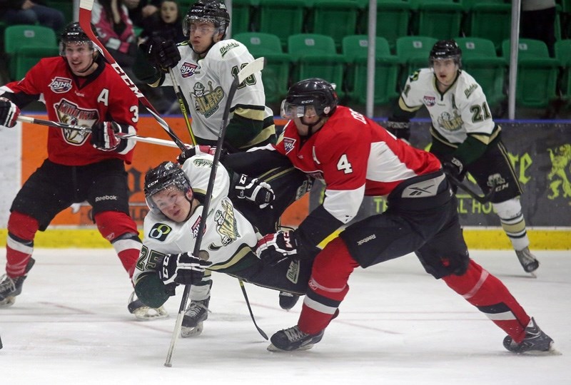 Okotoks Oiler Nolan Thompson is sent sprawling by Camrose Kodiaks defenceman Trevor Costello during Game 3 of the second round playoff series, March 22 at Pason Centennial