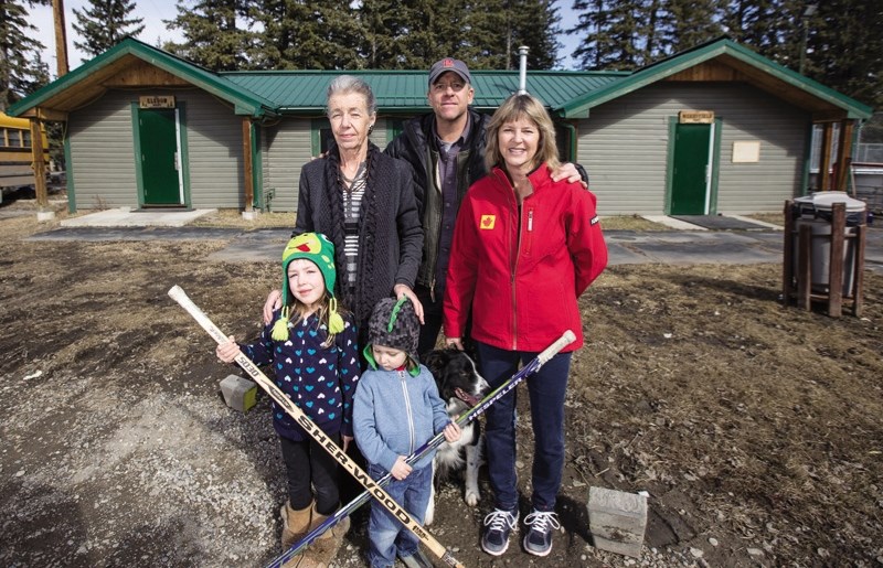 Barb Teghtmeyer, left, Terry Zimmel, Carol Storey, and little Taya and Jett Teghtmeyer in front of the Bragg Creek public hockey rink on March 19. Teghtmeyer was formerly an