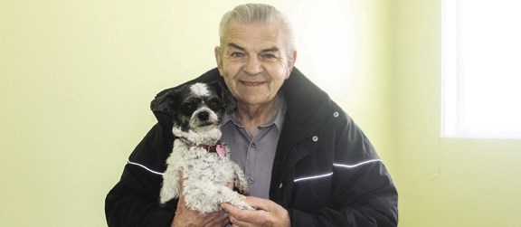 Willi Craciun with his bichon-shih tzu Maggie shortly after moving into the house that was donated by a Calgary company. Willi died in his home on March 9 at age 68.