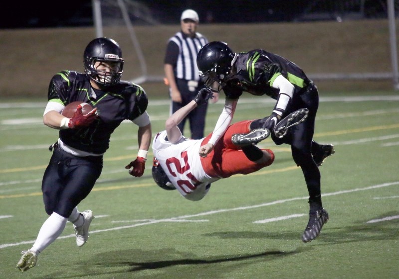 Big Rock Bengals runningback Jude Oh, left, follows the block of quarterback Tyson Pitcher during Big Rock&#8217;s 17-11 victory over the Calgary Stampeders on April 7 at