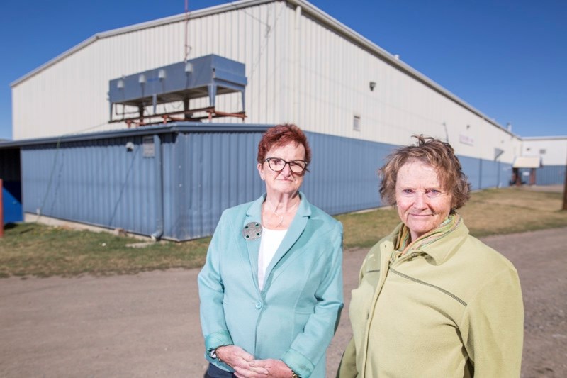 Black Diamond residents Maureen Henderson, left, and Jane Toews are asking the Town to take action regarding the noisy condenser fan on the outside of the curling rink