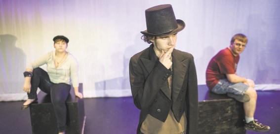 Mathew Gore delivers a monologue while Karissa Priest, left, and Kyle Snyder look on during a rehearsal of the Alberta High School of Fine Arts&#8217; Spoon River Anthology