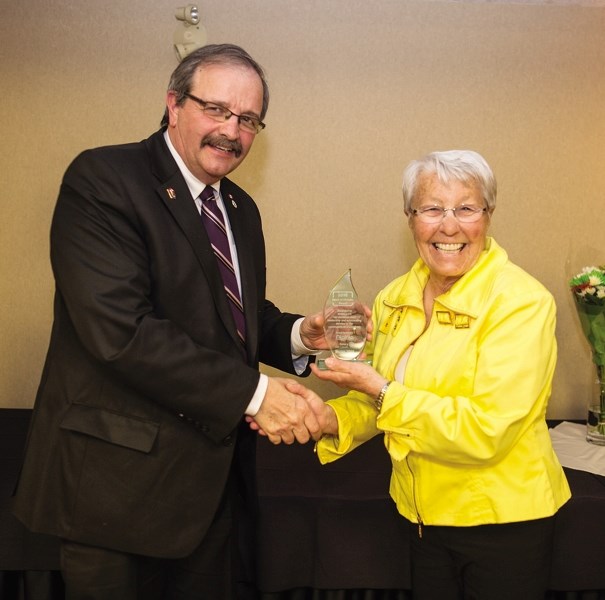 Okotoks resident Marg Cox receives the Heart of Okotoks award from Okotoks mayor Bill Robertson.