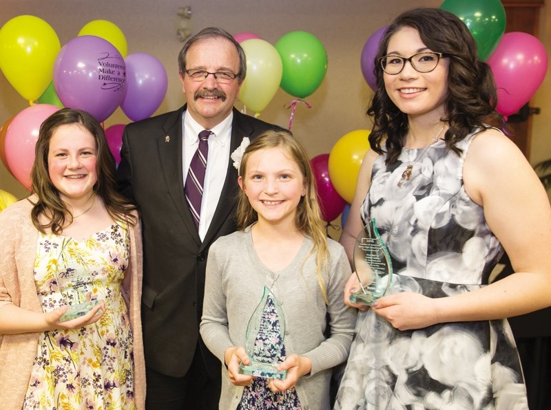 Winners of the 2016 Okotoks Leadership Awards receive congratulations from Okotoks Mayor Bill Robertson). From the Left, Leaders of Tomorrow award winner Emily Penzo, Okotoks 