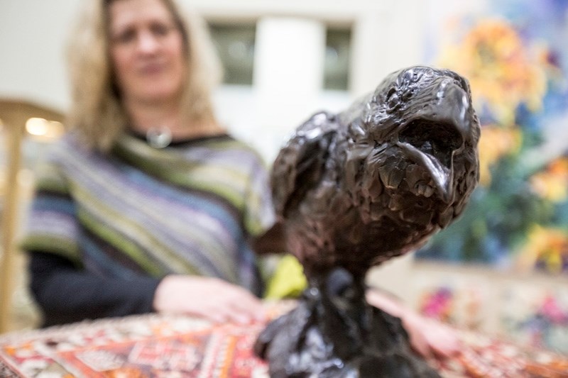 Bluerock Gallery co-owner Karen Gimbel with bronze statue Raven&#8217;s Voice, which was recently recovered as part of a major theft ring bust in Calgary after being stolen