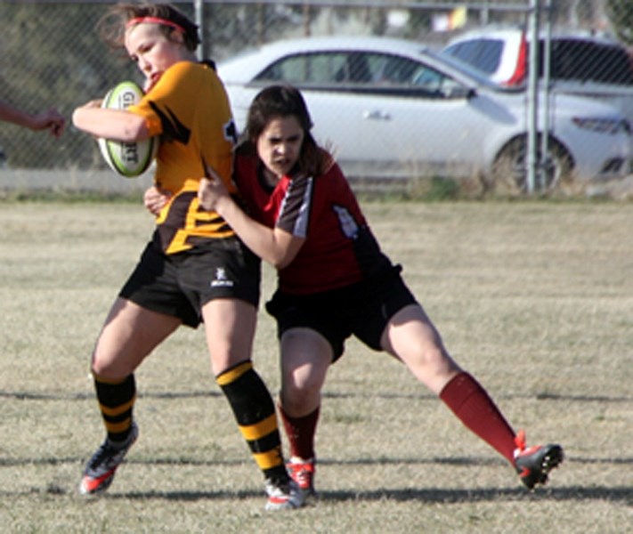 Oilfields Driller Tarran Klopp is hauled down by Foothills Falcon Claire Shirakawa in Big Sky Rugby Union action April 20 in Black Diamond. The Falcons won 37-5.