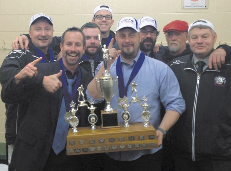 Jay McFarlane, left, and Mike Hannigan, middle, celebrate the Okotoks Bisons first provincial championship in 2013. McFarlane stepped down as GM after 10 seasons.