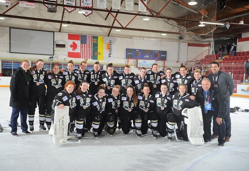 The Rocky Mountain Raiders gather for a team picture after capturing the bronze medal at the Esso Cup National Midget AAA Female Hockey Championship on April 23 in Weyburn,
