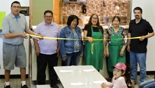 Chief Jacob Bearspaw School cook Nancy Lefthand cuts the ribbon to mark the opening of the newly renovated kitchen earlier this month. Pictured from left are Principal Bill