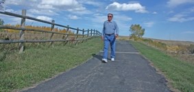 Ray Anholt walks on the Friendship Trail, which will soon connect with the Decalta Road trail by a new path Main Street after Turner Valley Town council approved the project