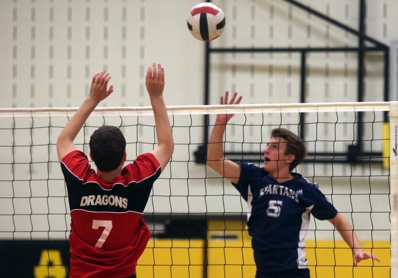 Strathcona-Tweedsmuir Spartan Nico Belanger spikes a ball against the St. Michael Dragons in the Oilfields Drillers Senior boys volleyball final Sept. 24 in Black Diamond.