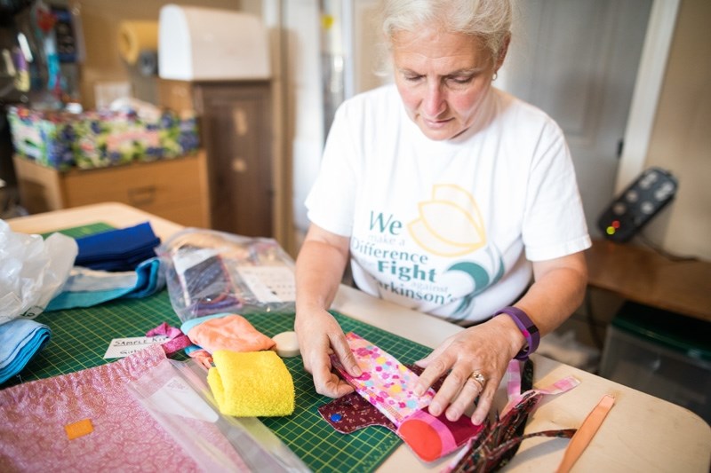 Black Diamond resident Felicity Lowinger assembles a reusable sanitary napkin kit to go to a women who does not have easy access to feminine hygiene products.