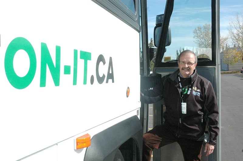 Okotoks Mayor Bill Robertson climbs on a bus for the Calgary Regional Transit&#8217;s On-It regional commuter transit pilot project on Oct. 3 at the Okotoks Recreation Centre.
