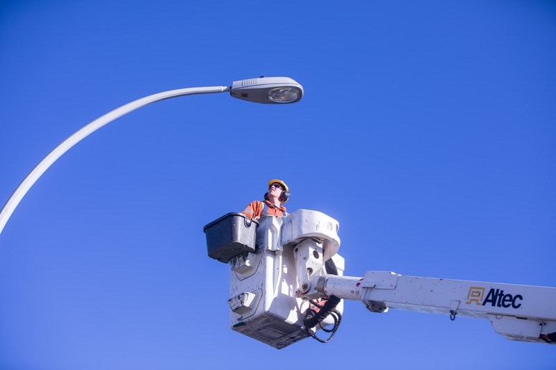 James West installs a new LED streetlight module in Cimarron on Sept. 24. The town will be changing from traditional streetlights to the more efficient LEDs.