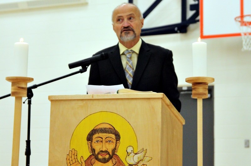Ron Schreiber, the new chairman of Christ the Redeemer Catholic Schools, speaks to students, staff and dignitaries at the St. Francis of Assisi Academy celebration and
