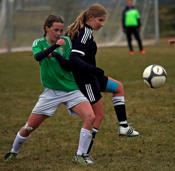 Holy Trinity Academy Knights midfielder Kayla Pagnotta juggles the ball past a Canmore Crusader defender during the Knights&#8217; 3-0 win, Oct. 17 at Riverside Park.