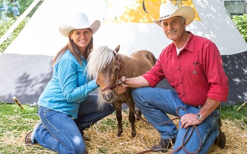 Sherry and Steve Caldera with their three-year-old miniature horse Peanut at the Calgary Stampede last summer. Peanut was killed by a cougar at their Priddis ranch in early