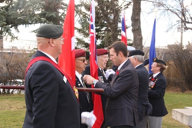 Foothills MP John Barlow joins the Royal Canadian Legion Okotoks Branch #291 in pinning poppies on the colour guard during the 2015 poppy campaign launch. This year&#8217;s