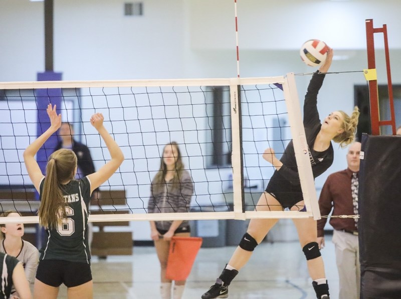 Foothills Falcon Jessa Meyer spikes over Strathcona-Tweedsmuir Spartan Hadley Rawling Oct. 19 at STS. The Falcons won the Foothills Athletic Council match 3-2.