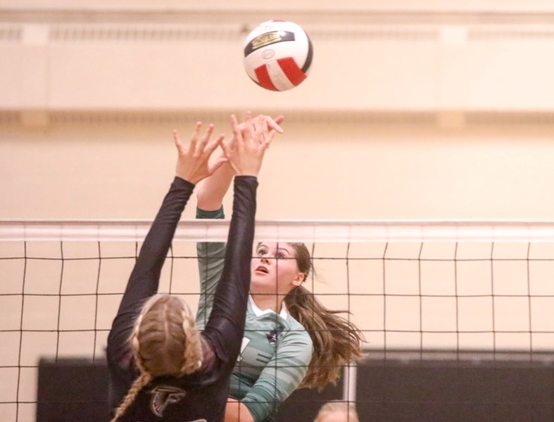 Holy Trinity Academy Knight Danielle Forester spikes over a Foothills Falcon on Oct. 26 at the Comp.