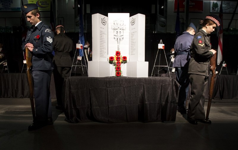 Cadets stand guard at a cenotaph at the 2015 Okotoks Remembrance Day ceremony. This year&#8217;s ceremony will be held at the Pason Centennial arena for the second year.