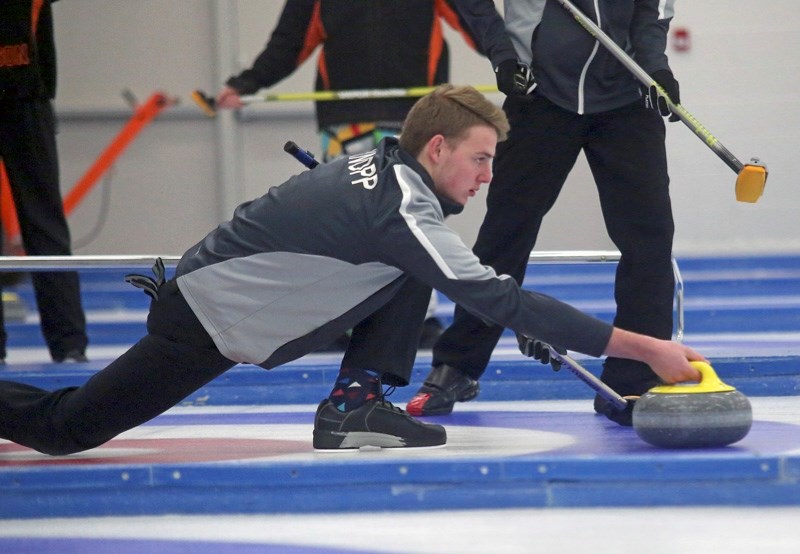 Winning skip Cailen Knopp of Okotoks comes out of the hack during the final of the Okotoks U18 Bonspiel.