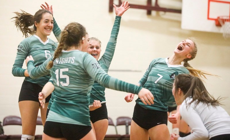 Holy Trinity Academy Knights (from left) Dora Komlodi, Katherine Brown, Danielle Forester, Julia Simard, Annelise Hielema and Cara Masi celebrate their four set victory over