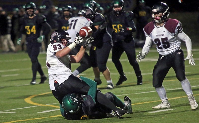 Linebacker Jacob Tighe dishes to a teammate after securing an interception in the Tier II Alberta Bowl versus St. Joes Celtics on Nov. 25 at Hellard Field. Foothills won the