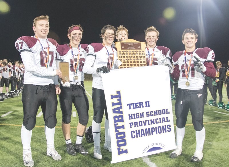 The Foothills Falcons captains pose with the Tier II Alberta Bowl banner after beating St. Joes 37-4 on Nov. 25 at Hellard Field. From left: McKay Mullen, Keaton Goossen,