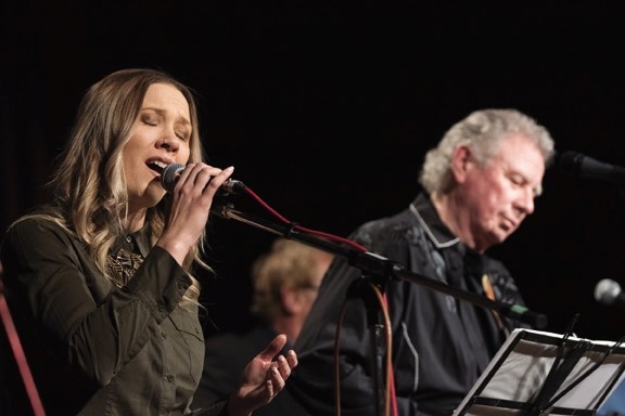 Caroline &#8220;Lady C&#8221; Fraser sings Joni Mitchell&#8217; s &#8220;River,&#8221; backed by father John Fraser on guitar at last year&#8217; s Food Bank Christmas