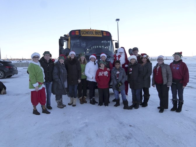 Santa and his elves ready to board their bus and deliver gifts and cheer to families in the Foothills in December 2015.