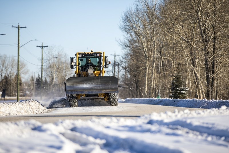 A grader clears snow from South Railway St. on Jan. 4.
