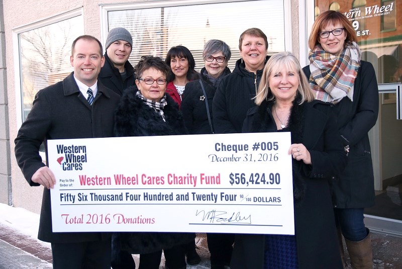 The Western Wheel Cares campaign handed out $56,424.90 for 2016 to seven Foothills charities. Pictured from the left, Western Wheel publisher Matt Rockley, Andrew Gustafson