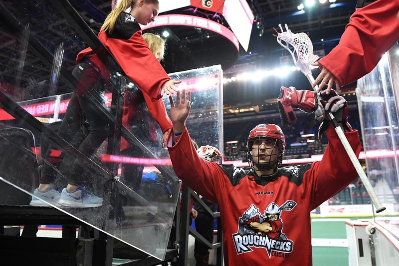 DeWinton native Holden Cattoni, a former Okotoks Raider, is high-fived while making his professional debut in the National Lacrosse League with the Calgary Roughnecks Jan. 7