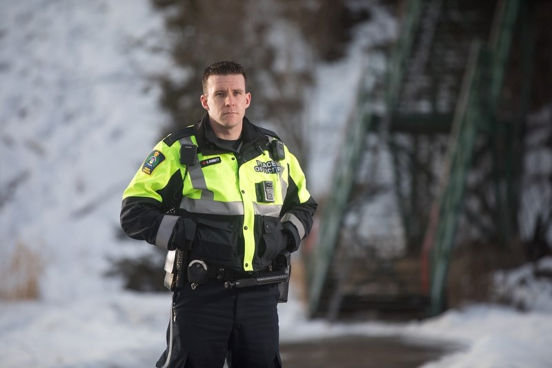 Okotoks Municipal Enforcement officer Sam Burnett in Sheep River Park on Jan. 31. Burnett was one of the officers who created a report to improve safety on the pathway that