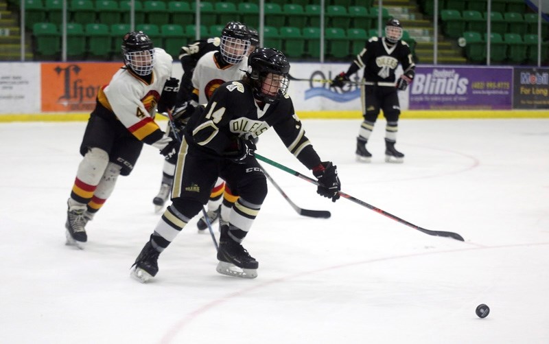 Okotoks Bantam AA Oilers forward J.J. Pickell digs for a loose puck in the team&#8217;s 4-2 victory over the Taber Golden Suns, Jan. 28 at Pason Centennial Arena. Pickell had 