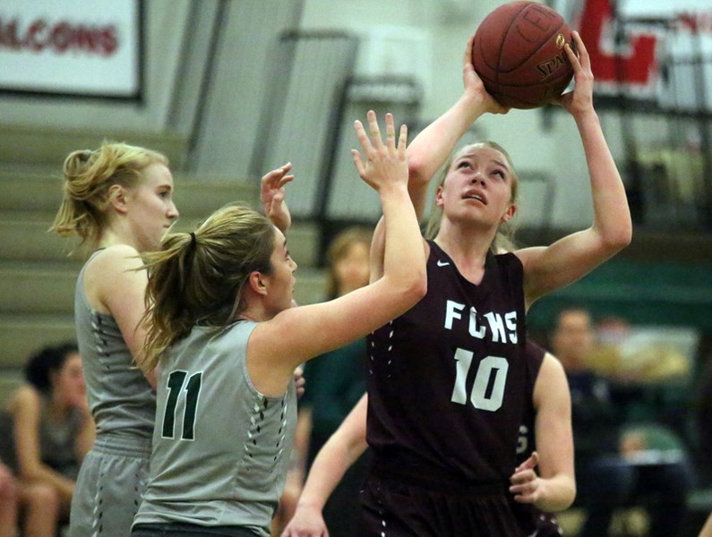 Foothills Falcon Alli Taylor (10) prepares to go up for a shot against the host Centennial Coyotes Feb. 10 in Calgary.