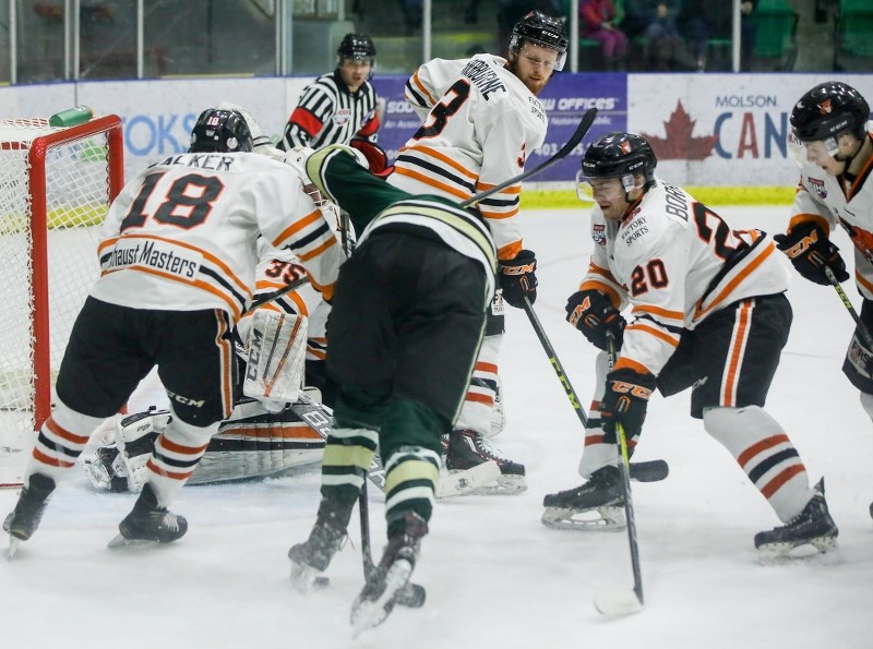 Okotokian Brendon Borbely of the Lloydminster Bobcats digs for a loose puck versus the Okotoks Oilers on Feb. 10 at Pason Centennial Arena. Borbely and the Bobcats won by a