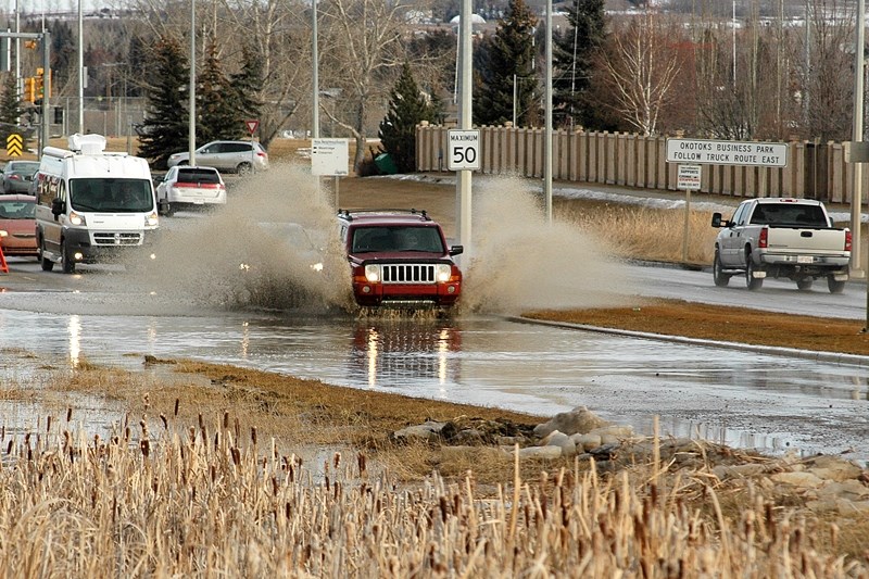 A car drives through a large puddle on Southridge Drive on Feb. 16.