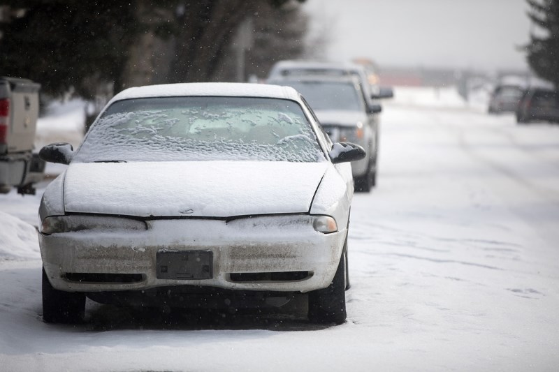 Cars rest on a street in north Okotoks on Feb. 24. Coun. Carrie Fischer is raising concerns about vehicles parked on streets for longer than 72 hours, potentially creating