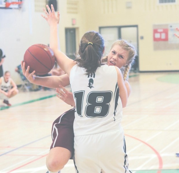 Foothills Falcon Hannah Helton drives to the basket against the Holy Trinity Academy Knights in last year&#8217; s FAC final. The two Okotoks school will meet for the first