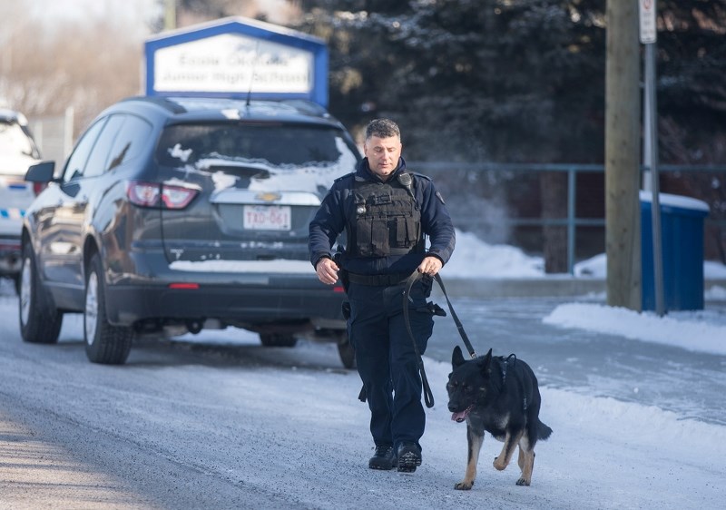 A police canine unit leaves Okotoks Junior High School on March 9 after a threat was reported the day prior.