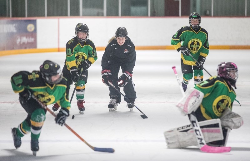 U of C Dinos forward Sara Craven works on skating technique with the Okotoks Oilers Atom White Girls on March 1 at the Piper Arena.