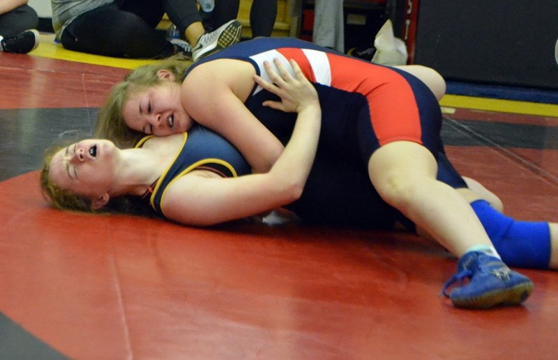 Holy Trinity Academy Knight Sadie Watkins nearly pins Bev Facey Facey Falcon Rebecca Powell in the 61kg high school provincial semifinal March 11 in Calgary.