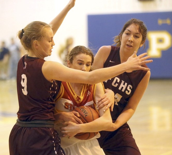 Foothills Falcon Teah Simard (9) and Cevanna Carlson (14) smother Strathcona Lord Madison Chamberlin at 4A high school girls provincials March 16 at Magrath.