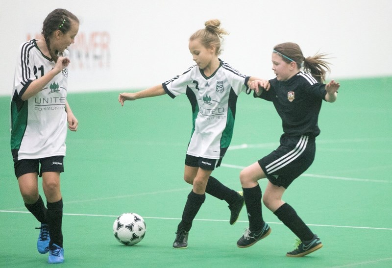 Okotoks United&#8217; s Lainey Fischer fires a shot on goal with teammate Billie Bowers nearby during the Tier IV U12 girls provincials on March 18 at the Crescent Point