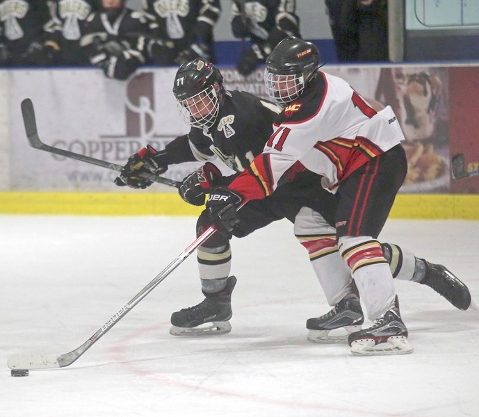 Okotoks Bantam AA Oilers forward Connor Poffenroth battles with his opposite number West Central Tiger Ashlain Dufresne during Game 3 of the SCAHL league championship on