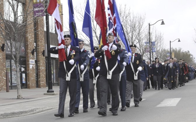 The colour guard leads a parade of veterans, Legion members, cadets, first responders and Scouts Canada members from the Elks Hall to the cenotaph in Frederick Pryce Memorial 