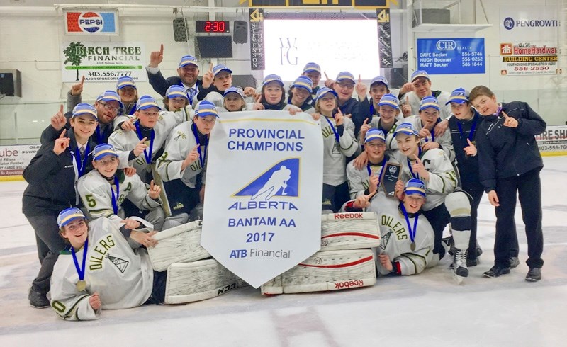 The Okotoks OIlers celebrate their Bantam AA provincial championship on April 2 in Olds.